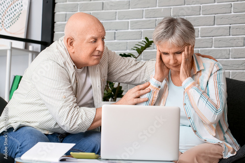 Stressed senior couple with...
