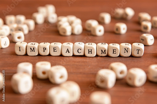 Word IMPEACHMENT made of cubes on wooden background