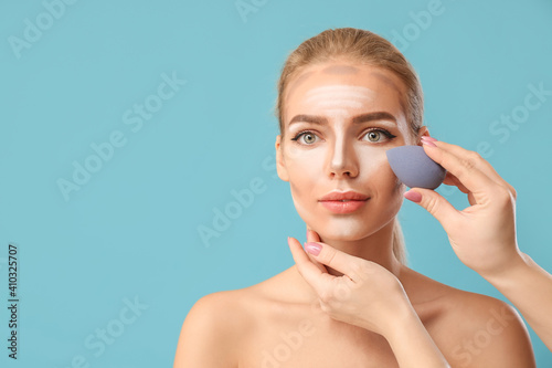 Cosmetologist applying cont...