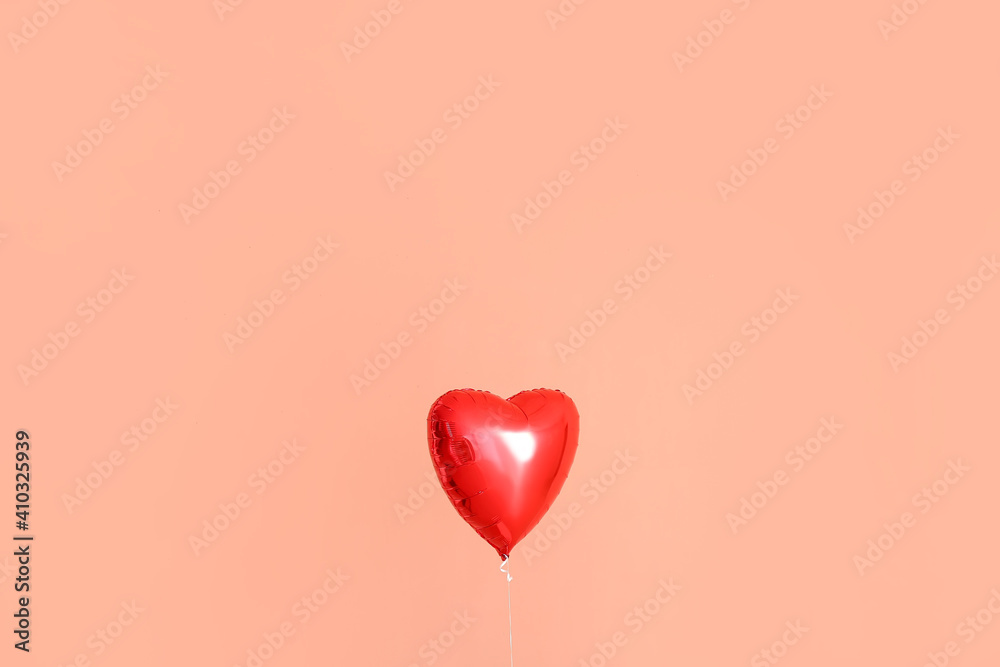 Heart shaped air balloon on color background