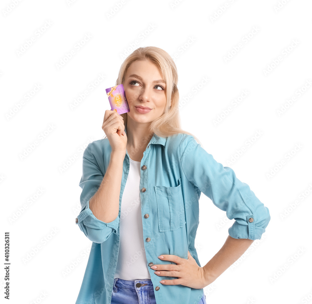Beautiful young woman with gift card on white background