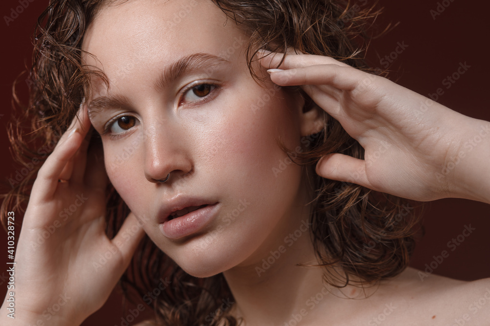 Fototapeta premium beautiful girl with clean beautiful healthy skin on a wine background. Skin care face . Cosmetology