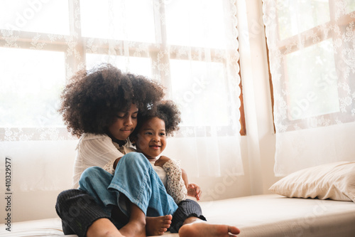 African American children  girl having fun to play with her sister, childhood family at home concept
