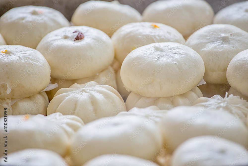 Delicious baozi, thai steamed meat bun is ready to eat on serving plate and steamer