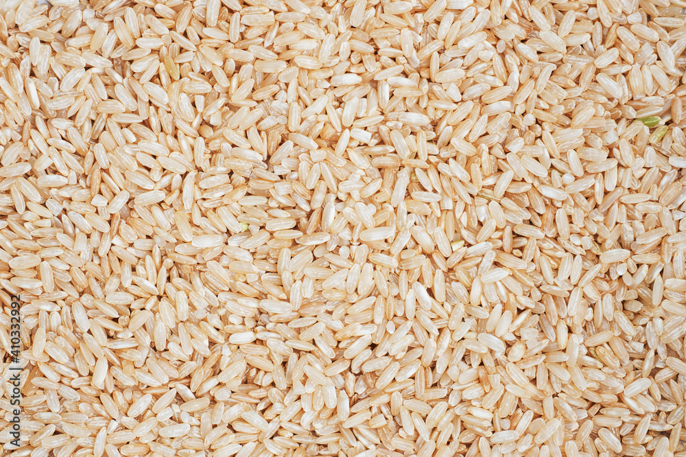 Texture Brown rice raw long grain. background close up.