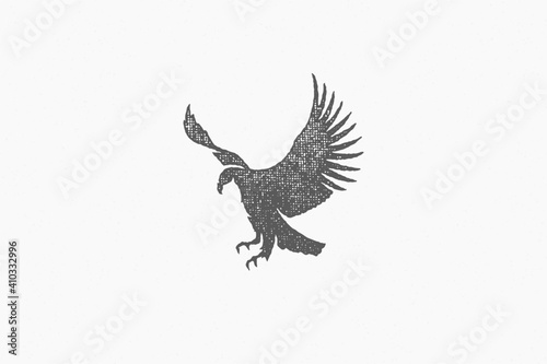Black silhouette wild eagle soaring in sky in countryside hand drawn stamp effect vector illustration.