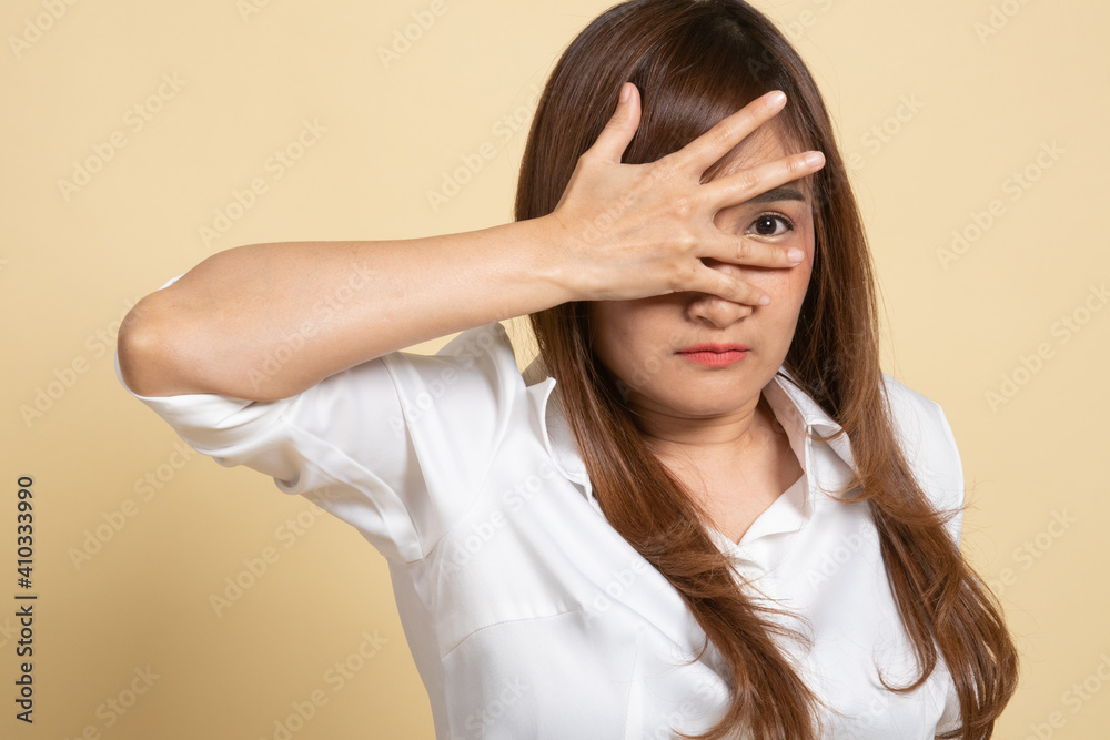 Beautiful young Asian woman peeking through fingers. Beautiful young Asian woman peeking through fingers.