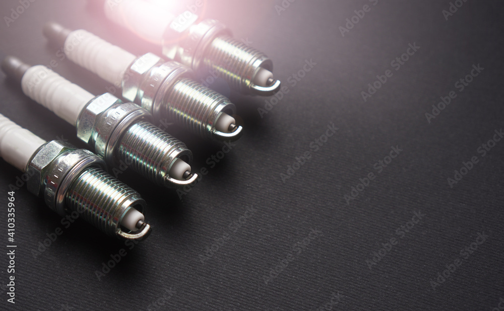 New automobile spark plugs on a dark background with copy space New automobile spark plugs on a dark background with copy space