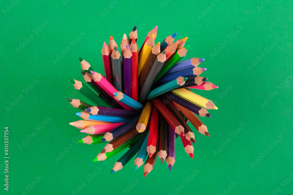 Top view of color pencils isolated on green background Top view of color pencils isolated on green background