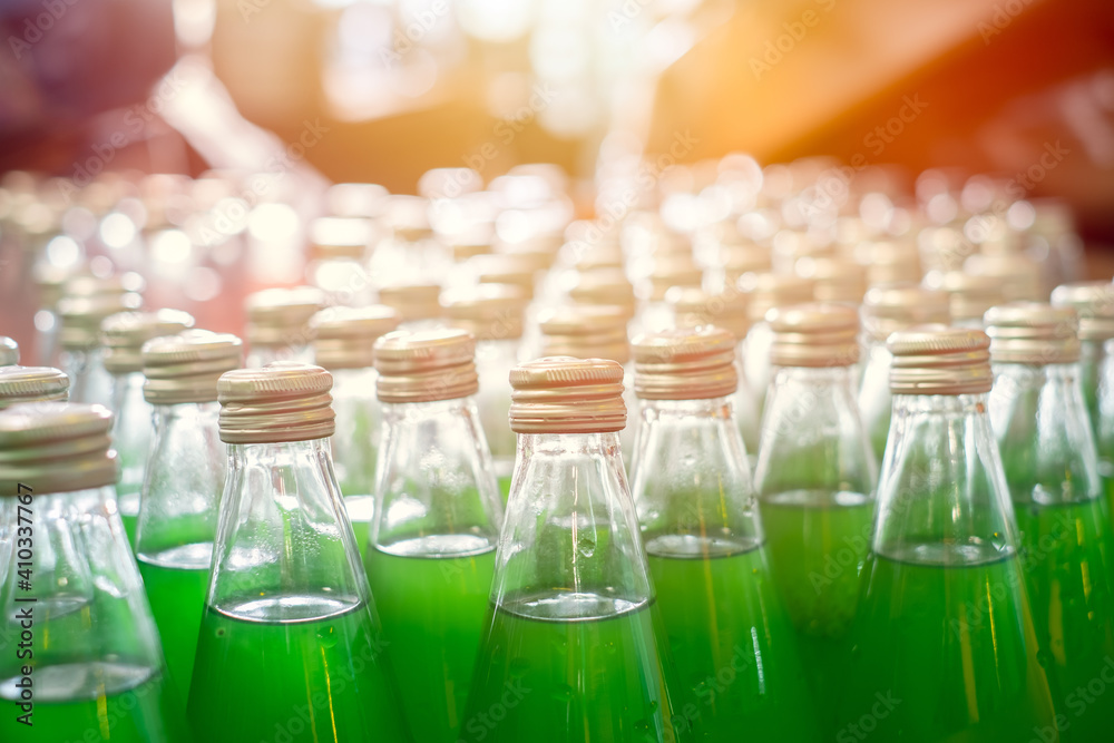 Sweet sugar beverage drink green colored in glass bottle in factory Sweet sugar beverage drink green colored in glass bottle in factory
