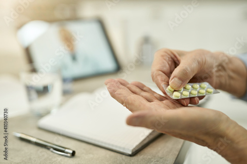 Elderly person taking medication per doctor prescription