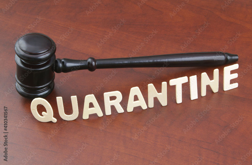 Wooden judge gavel with word quarantine. Concept laws against covid-19. Wooden judge gavel with word quarantine. Concept laws against covid-19.
