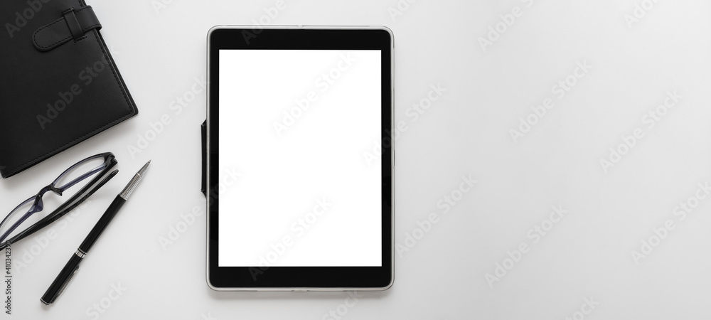 contemporary office workspace with white screen digital tablet, notebook, and office supply on white background contemporary office workspace with white screen digital tablet, notebook, and office supply on white background