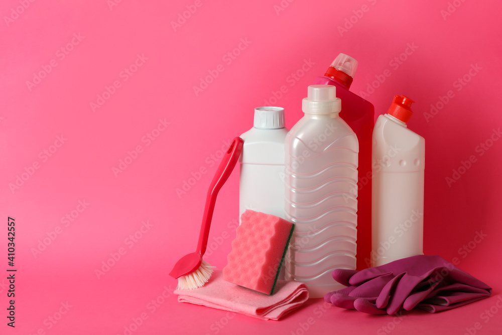 Group of different cleaning tools on pink background Group of different cleaning tools on pink background
