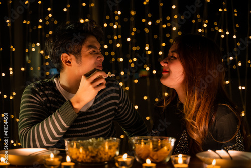 young couple celebrate at night party, romance date and love concept for Valentine's Day, dinner with night candle light, cozy with couple family at home