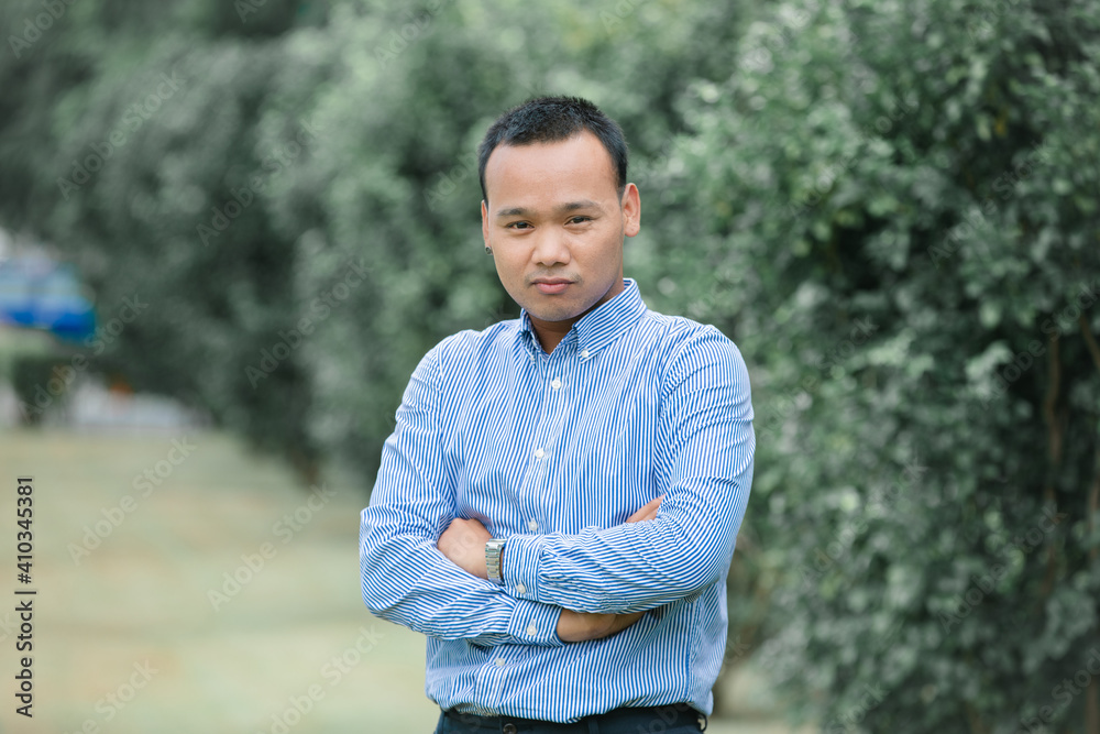 Portrait of Thai gay man pose with confidence and happiness on nature background. Portrait of Thai gay man pose with confidence and happiness on nature background.