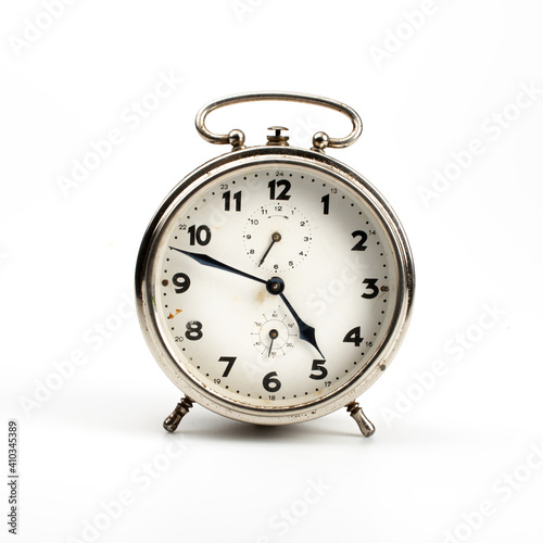 Silver vintage alarm clock on white background