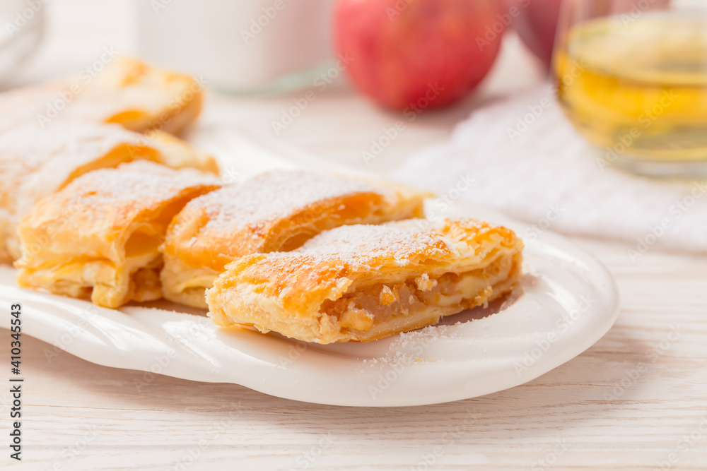 Homemade apple strudel (apfelstrudel) on white plate Homemade apple strudel (apfelstrudel) on white plate