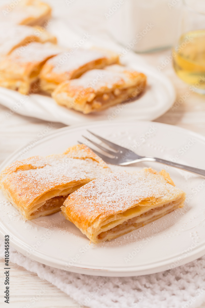 Homemade apple strudel (apfelstrudel) on white plate