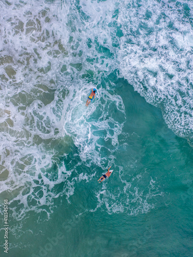 Aerial photograph of surfers in crashing waves © andriislonchak