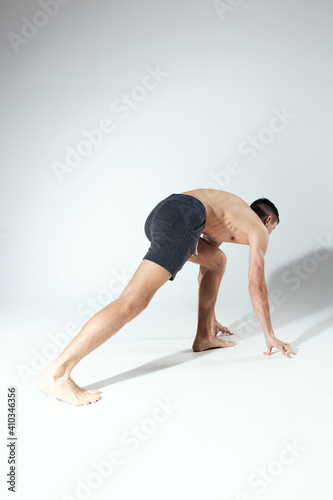 man running in a bright room sports fitness shorts model