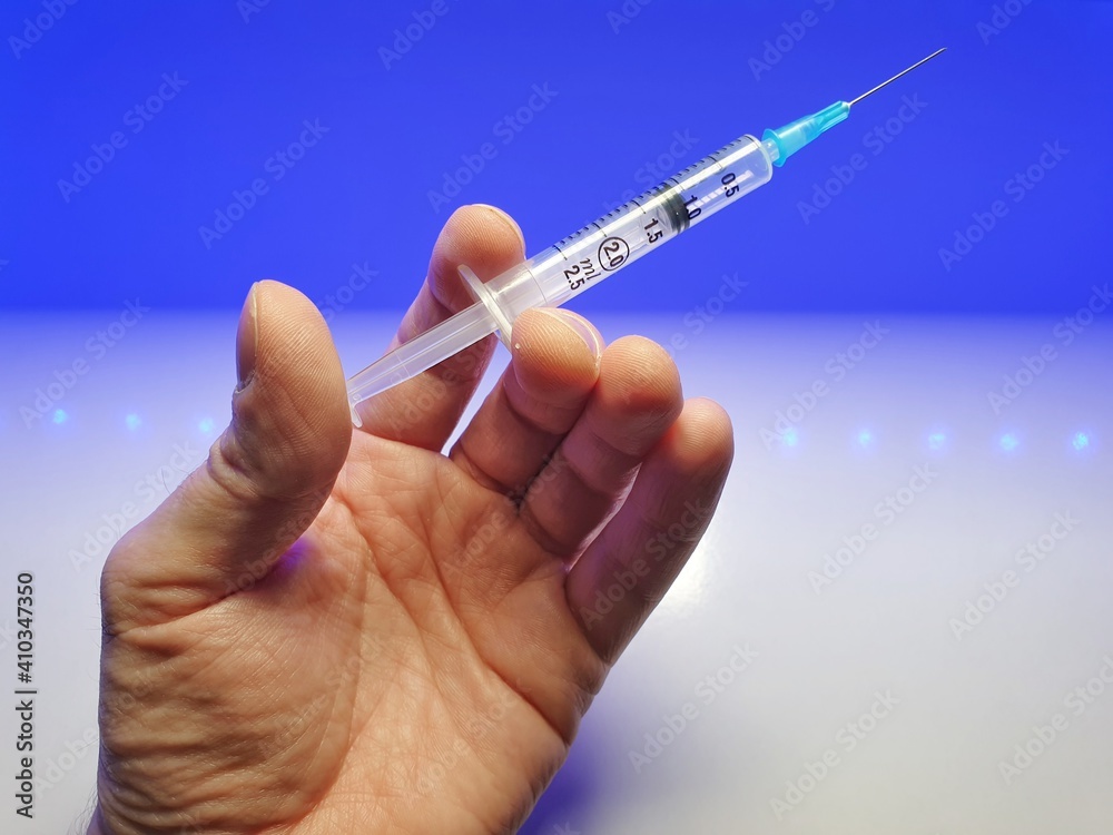 hand holding syringe for covid-19 hand holding syringe for covid-19