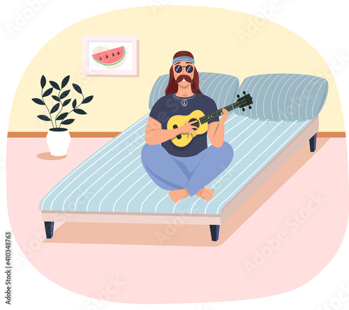 Male hipster bard with ukulele in hands. Musician is playing strings on instrument. Person creates music. Man with musical instrument. Guitarist playing guitar on bed in living room