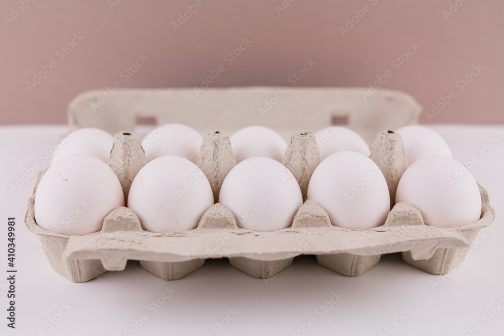 fresh raw chicken eggs in a cardboard tray on a white background fresh raw chicken eggs in a cardboard tray on a white background