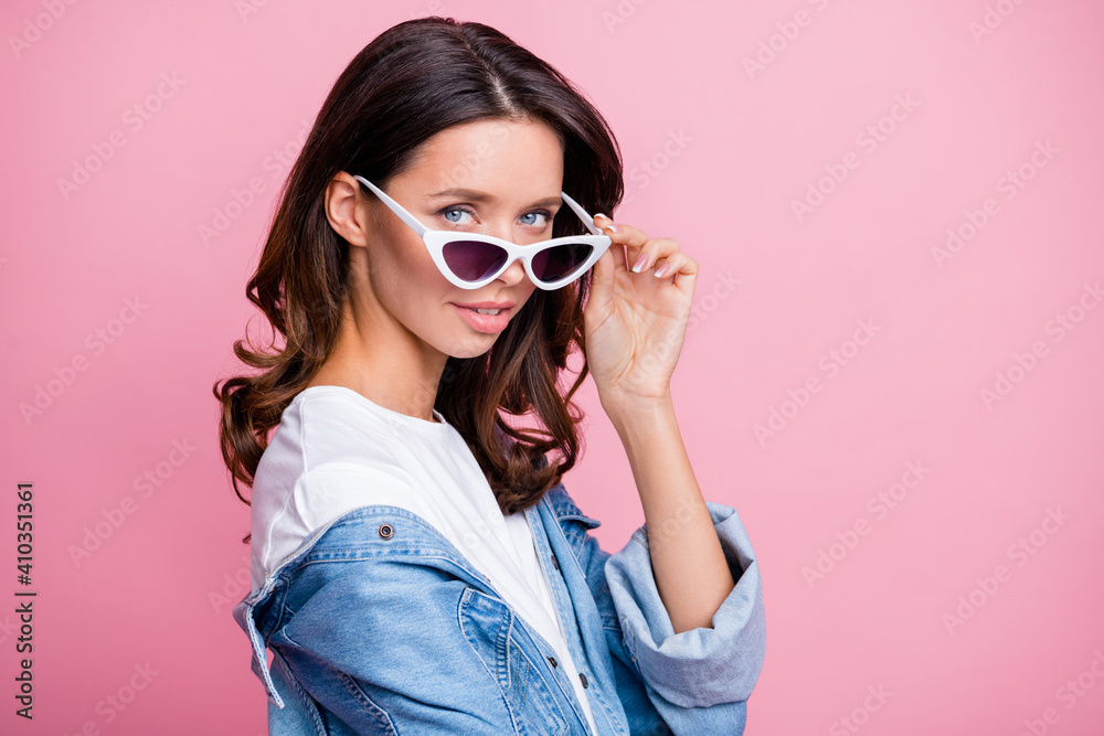 Profile side photo of attractive gorgeous lady look hold glasses stand empty space isolated on pastel pink color background Profile side photo of attractive gorgeous lady look hold glasses stand empty space isolated on pastel pink color background