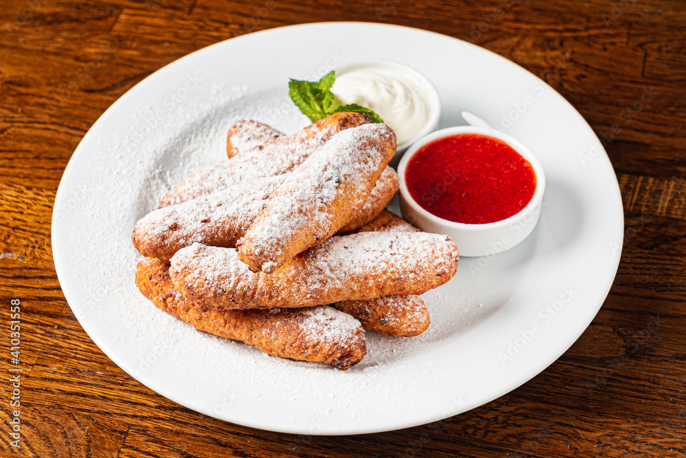 deep fried donuts with berry sauce deep fried donuts with berry sauce