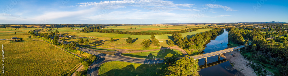 Wide aerial panorama of Princes Highway passing through Australian countryside at sunset