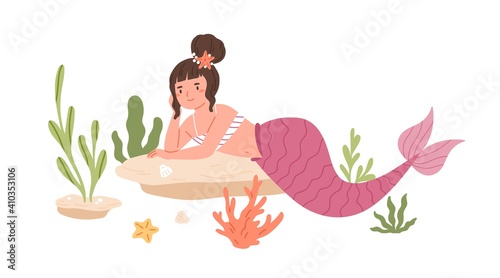 Pretty mermaid with hair bun and pink fish tail lying and resting at sea bed....