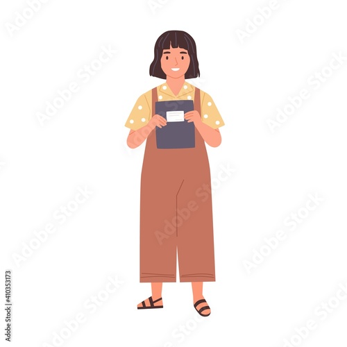 Smiling schoolgirl holding school notebook in her hands. Happy girl with bob hairstyle. Kid in overalls carrying exercise book. Colored flat vector illustration isolated on white background