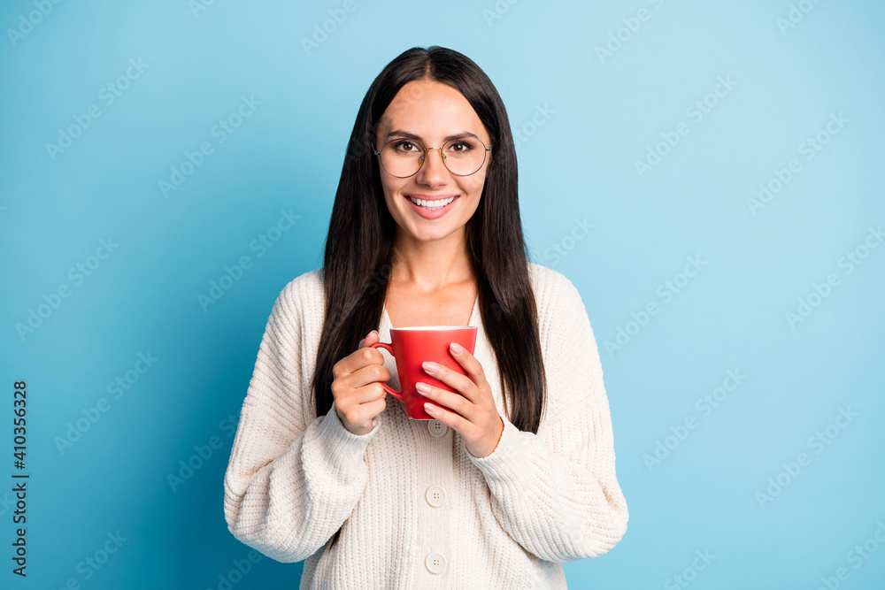 Portrait of adorable girl arms hold coffee cup eyewear good mood isolated on pastel blue color background Portrait of adorable girl arms hold coffee cup eyewear good mood isolated on pastel blue color background
