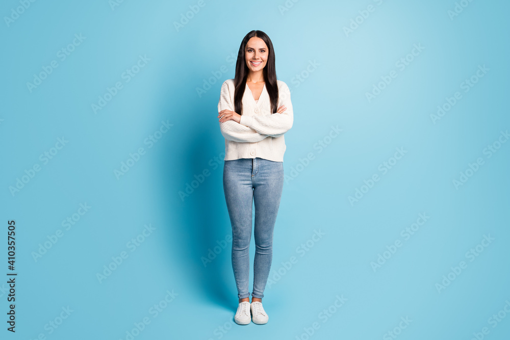 Full size portrait of pretty friendly person folded arms toothy smile isolated on blue color background Full size portrait of pretty friendly person folded arms toothy smile isolated on blue color background