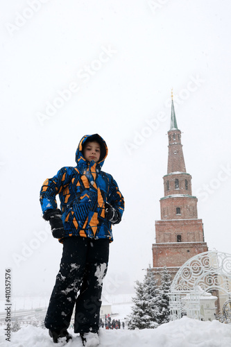 Kid on background of Syuyumbike tower in Kazan Kremlin photo