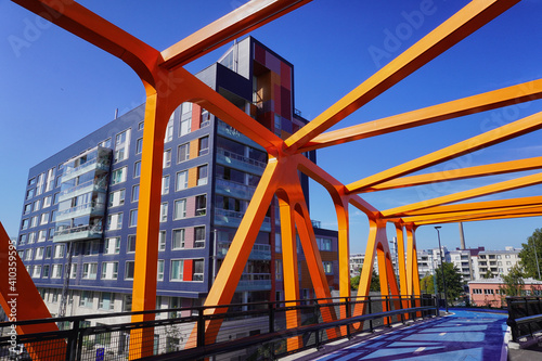 Orange steel structure of a modern bridge in Jätkäsaari, a new district in Helsinki