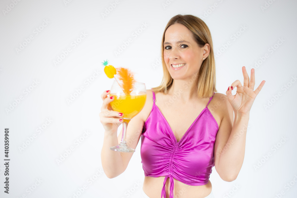 Young beautiful blonde woman drinking glass of healthy orange juice over white background Young beautiful blonde woman drinking glass of healthy orange juice over white background