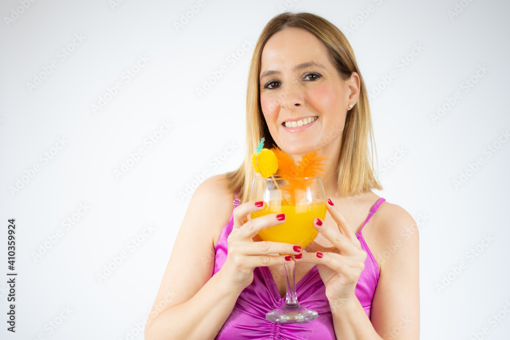Young beautiful blonde woman drinking glass of healthy orange juice over white background Young beautiful blonde woman drinking glass of healthy orange juice over white background