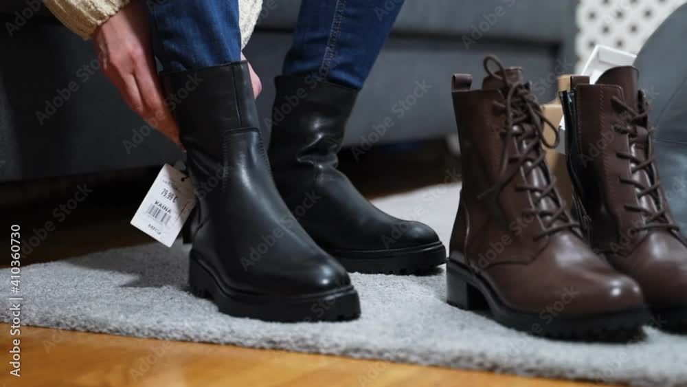 Woman tries on shoes in showroom. Woman tries on shoes in showroom.