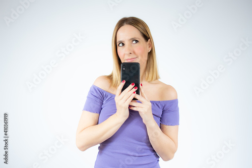 Portrait of beautiful woman using mobile phone, isolated over white background.