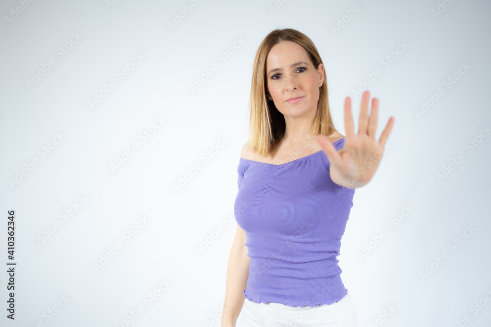 Portrait of a beautiful woman showing stop sign with palm isolated over white background Portrait of a beautiful woman showing stop sign with palm isolated over white background