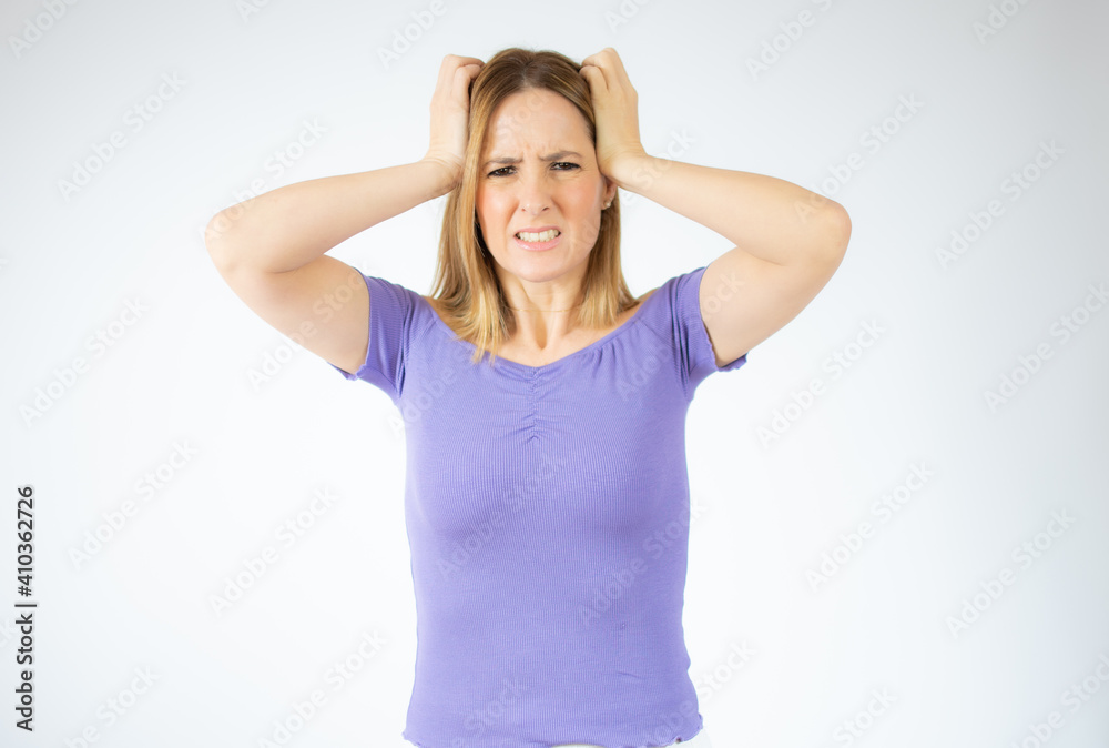 Portrait of a young angry woman over white background. Portrait of a young angry woman over white background.