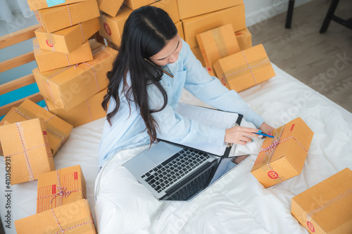Young Asian female packing ...