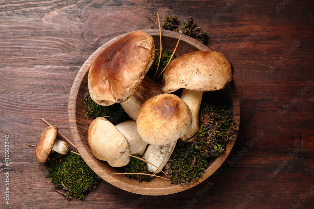 Fresh wild porcini mushrooms on wooden table, top view Fresh wild porcini mushrooms on wooden table, top view