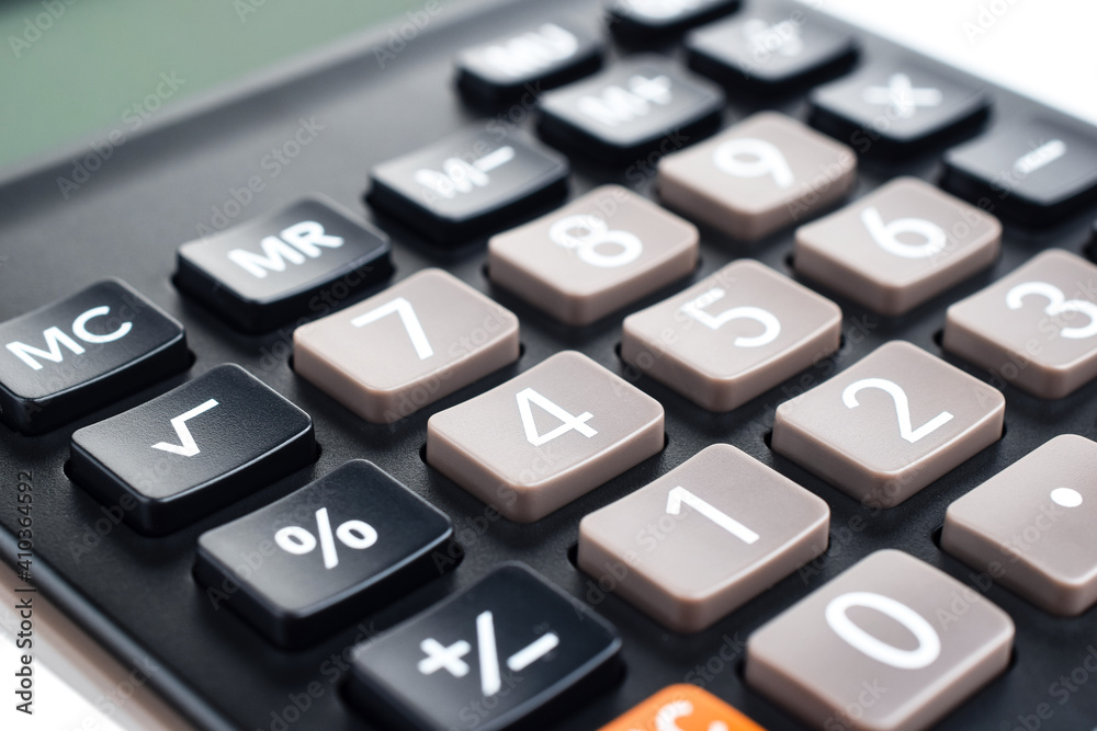 Black plastic digital calculator, isolated on a white background, close-up. Symbol economics, mathematics, accounting, finance concept. The day of knowledge, to calculate, to count money Black plastic digital calculator, isolated on a white background, close-up. Symbol economics, mathematics, accounting, finance concept. The day of knowledge, to calculate, to count money