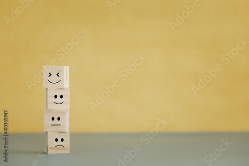 emotion faces on wooden cubes for satisfaction survey