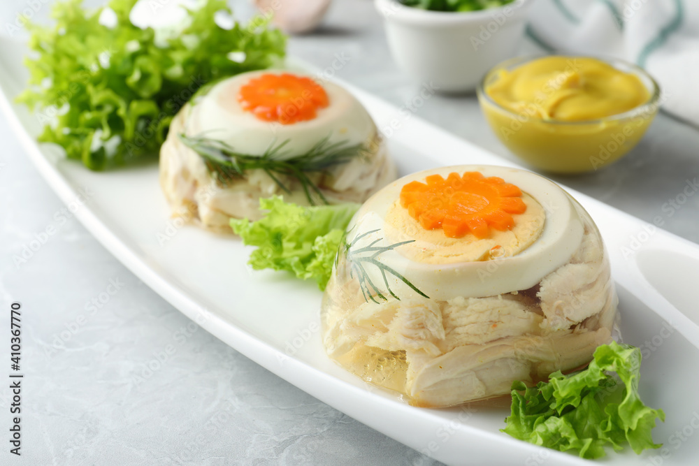 Delicious chicken aspic served on light grey table, closeup