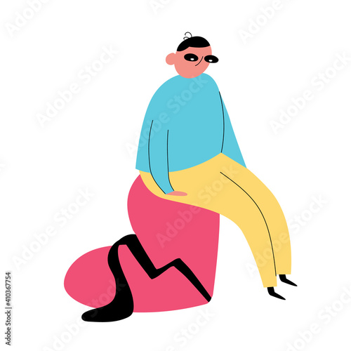 Cartoon man sits on a broken heart. A sad, lonely man. Breakup of the relationship. Flat style. Color vector illustration drawn on a white isolated background.