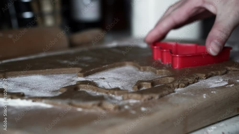 Caucasian female making tree-shaped gingerbread cookies. Caucasian female making tree-shaped gingerbread cookies.